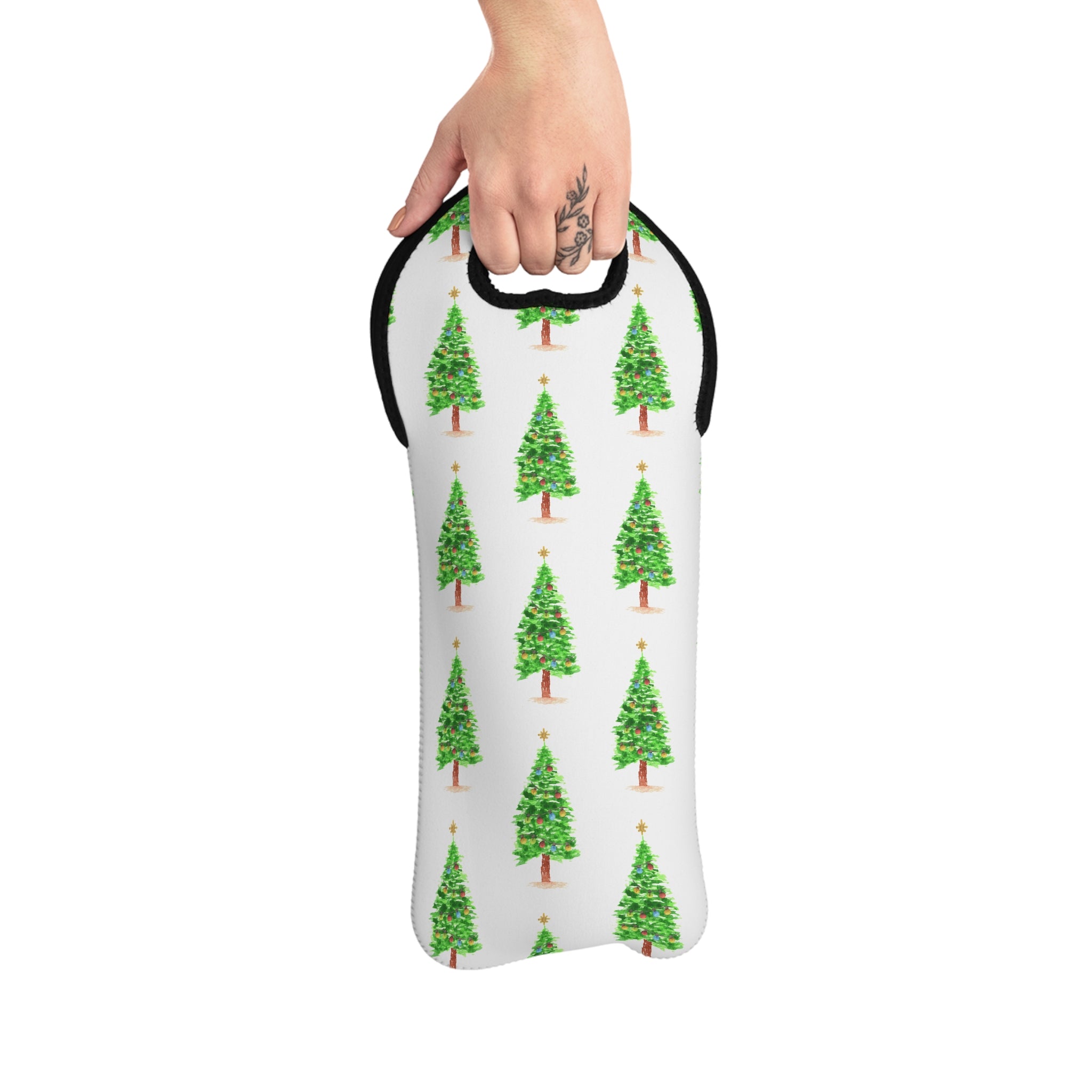 Hand holding a white bag with green Christmas tree pattern on a white background